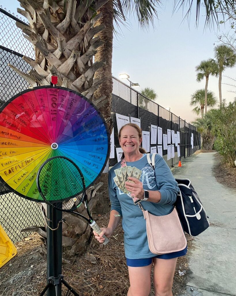 Tennis player winning money.