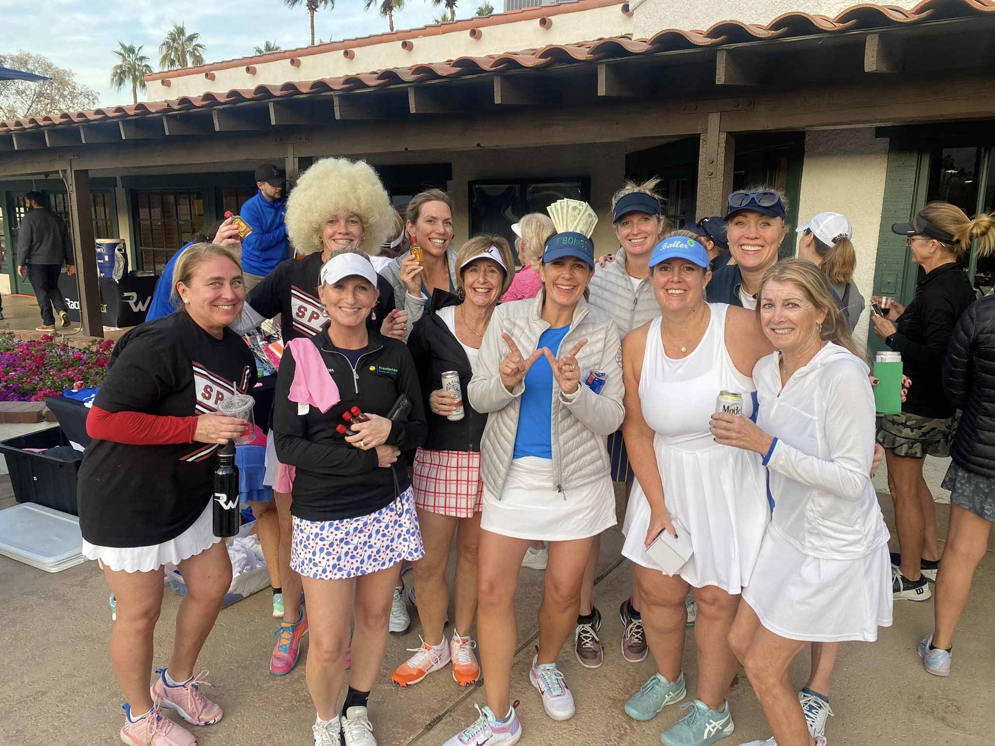 Players enjoying a Racquet War tennis tournament