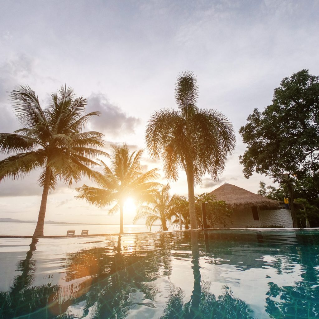 Sea with resort and sunset